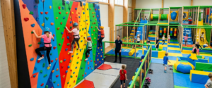 Colourful indoor climbing wall at a play centre, illustrating rock climbing at a play centre for active kids